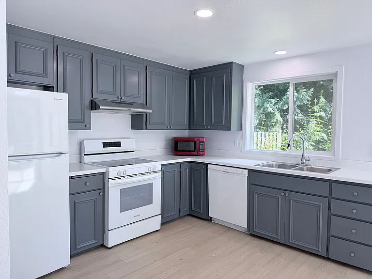The kitchen has been thoughtfully updated, creating a fresh, modern feel.