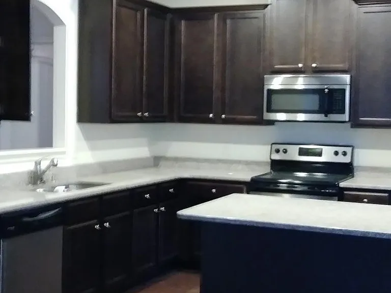 GRANITE COUNTERS TOPS
DARK WOOD CABINETS