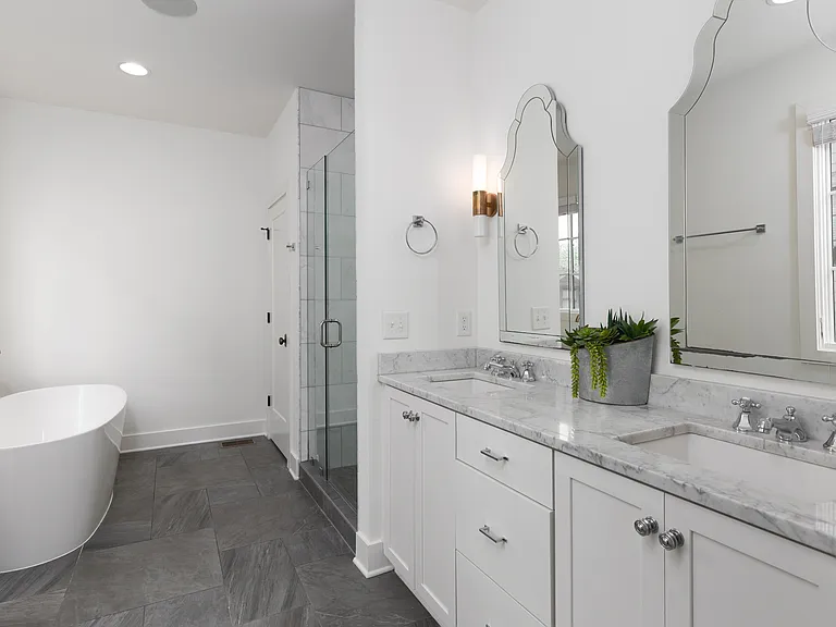 Full Bathroom connected to bedroom 1 with double vanity, shower, and large bathtub.
