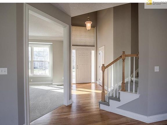 Light & bright TWO-STORY ENTRY featuring hardwood floors!