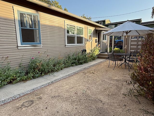 Front of unit with nice patio and storage unit