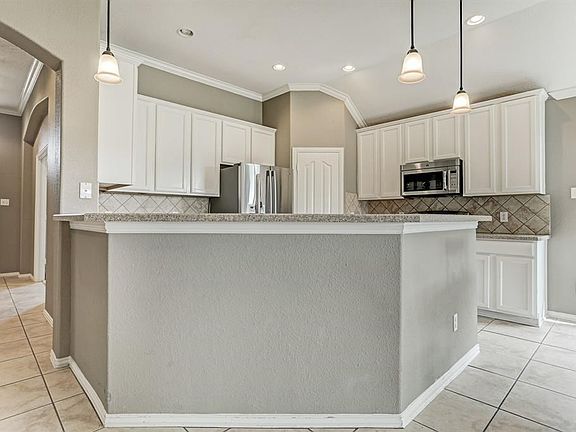 Entrance To Home With Tile Floors That Extend To Of Areas Of The Home.