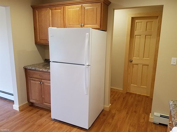 extra work space next to refrigerator in kitchen.