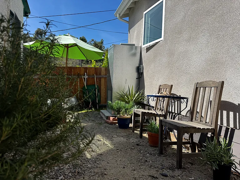 back patio with a hillside view