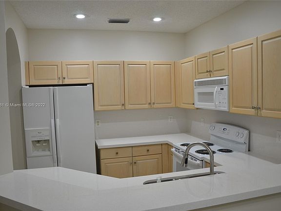 Kitchen with new quartz countertops and backsplash.  All appliances are under a service contract.