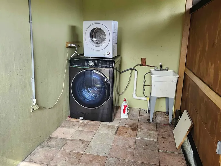Private Porch with a dryer and washer machine.