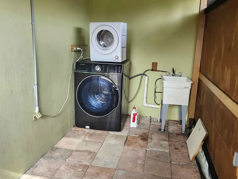 Private Porch with a dryer and washer machine.