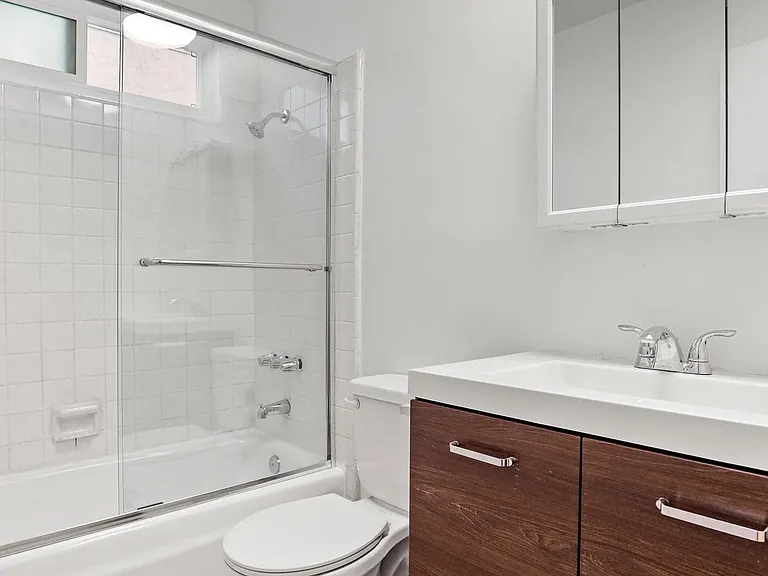 Bathroom with Bathtub and Vanity with Cabinet and Drawers