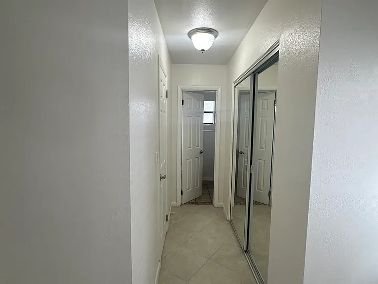 Master/Main bedroom hallway to walking closet, closet and primary bathroom view from main bedroom.