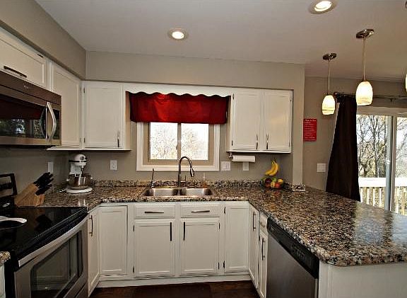 This kitchen shows the open floor plan of this upper level complete with kitchen window that overlooks the yard.