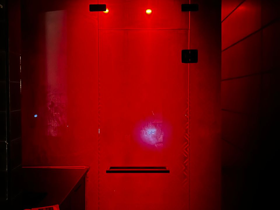 Spacious steam shower featuring red light therapy for a soothing and rejuvenating experience.