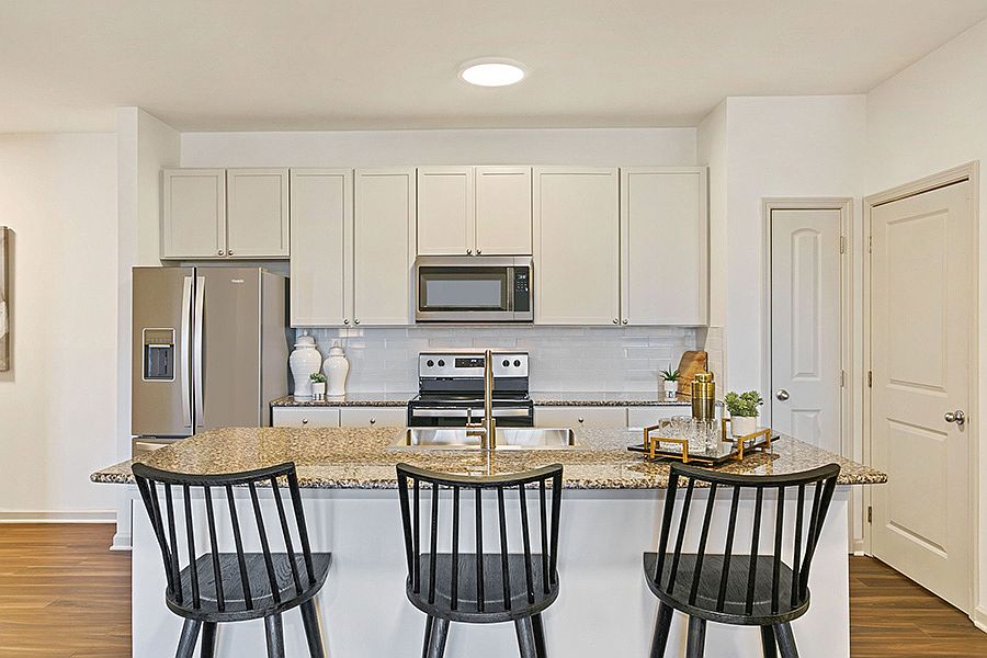 Beautifully renovated kitchens feature granite countertops, over-sized tile backsplash and smooth-top range