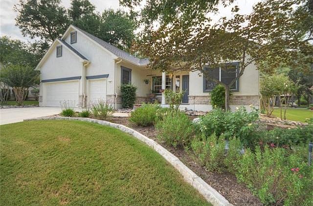 A Golf Cart Garage adjoins the roomy Two-Car Garage at this unique Sun City Texas Pecos located on a pretty, curvy street near the main entrance into this active-adult Mecca.