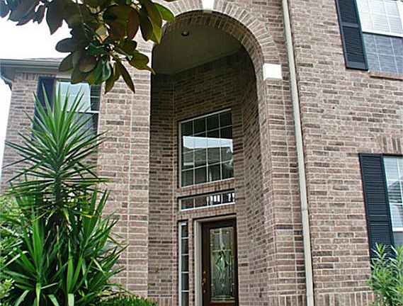 Lush landscaping is kept green by a sprinkler system.