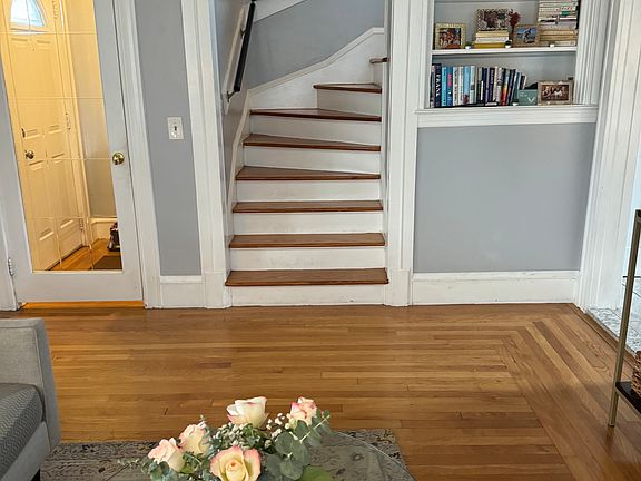 Another view of the stairs to the second level and a built-in book shelf.