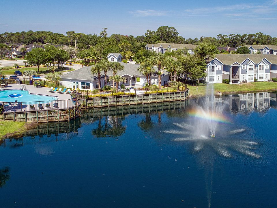 Experience the harmony of lakeside living at Indigo Isles, nestled amidst tranquil wooded areas, with stunning lake views and a large sundeck by the pool.