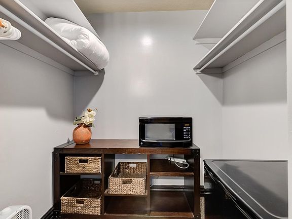 Microwave and Mini Fridge in Bathroom Closet
