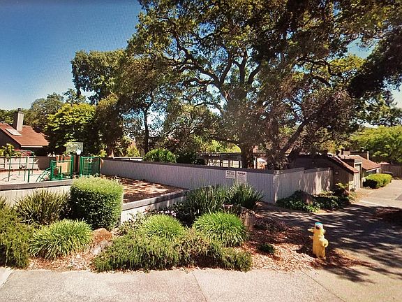 Directly across the street. Note fence around playground: Softens sounds of happy kids, and keeps them from making a break for it.