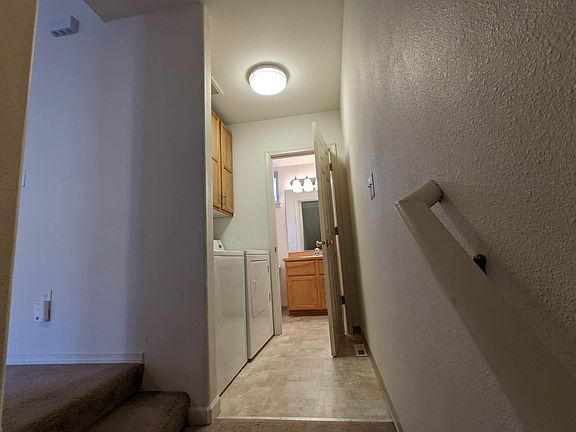 view from stairs to laundry and 1/2 bath