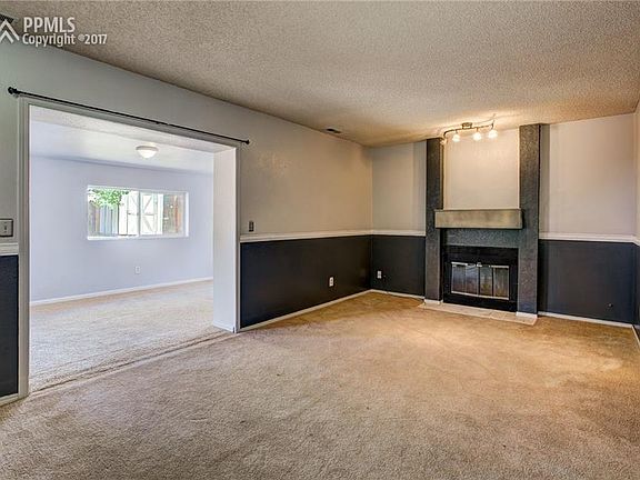 Lower Level Living Room With Wood Burning Fireplace