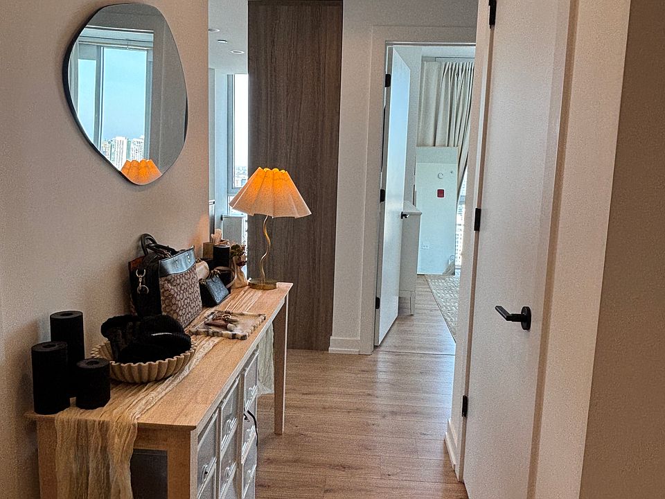 Entryway hallway with coat closet (right) and guest bathroom (left).