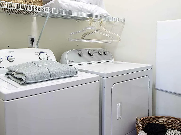 Experience ultimate convenience with this well-equipped laundry room.