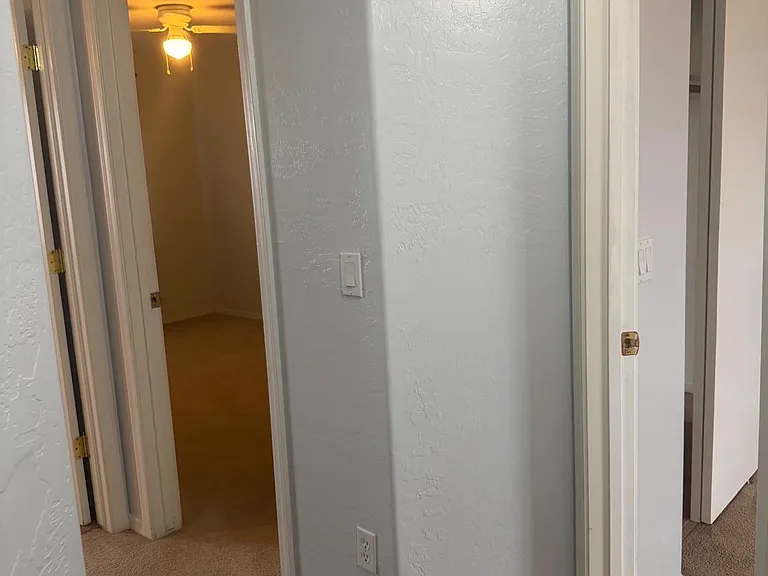 In the hallway with the master bedroom on the immediate right, the room with the light on is bedroom 2, and bedroom 3 is to the left of #2. The guest/hallway is a full bathroom oppoite of bedroom 2.