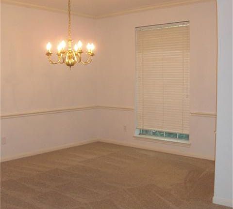Elegant formal dining room with crown moulding/chair railing and new carpet