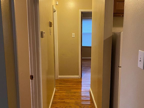 Hallway...freshly re-done hardwood floors! Fresh Paint! New lighting throughout!