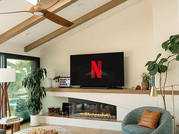 Smart TV 77" and gas fireplace.