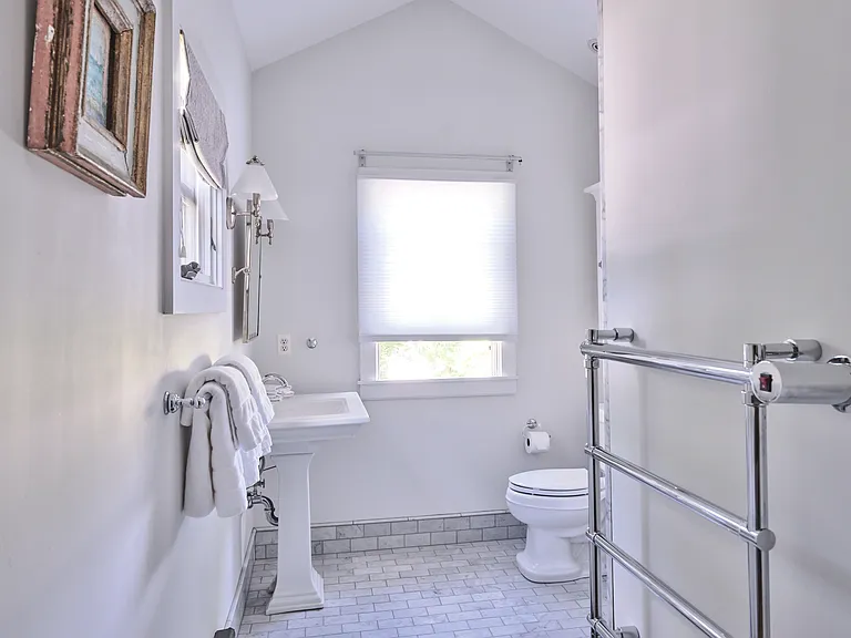 Primary Suite Bathrom - Heated Towel Rack and view into the back garden.