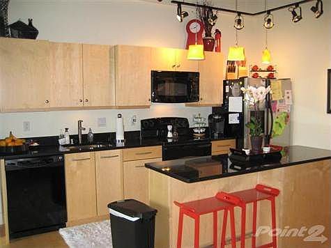 Kitchen with plenty of cabinet and counterspace.  Granite countertops.  Island/bar area.