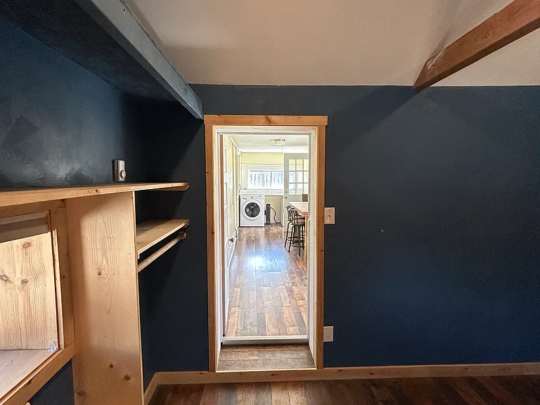 Looking out from the bonus room toward the famously awkward hallway _ it's spunky, it's long, and it's surprisingly useful. This spot's got personality for days and connects your cozy hideaway to the rest of the home with a little extra charm!