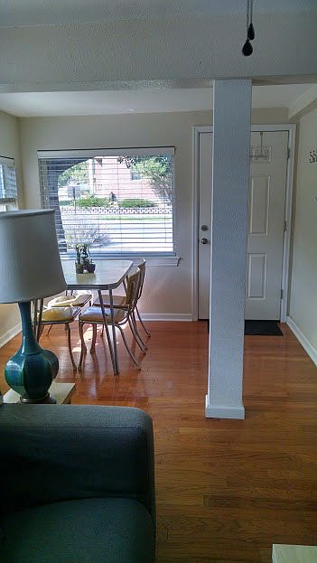 Front entry with large picture window and front yard with shade tree