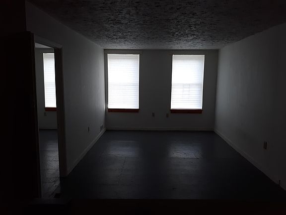 Living room with bedroom at the left of this frame