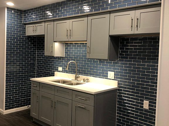 Gorgeous royal blue subway tile, soft close cabinets, designer studio41 faucet, under cabinets lighting
