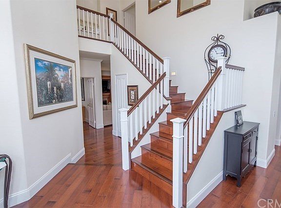 Beautiful Double-Door Entry with Elegant Staircase and Wood Flooring!