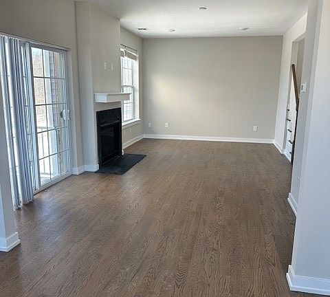 dining room and living room view with gas fireplace and an outside deck area.