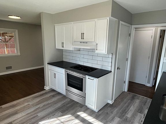 High end Leathered black granite adds elegance. Open to dining area and living room