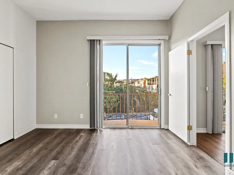 Bedroom with Closet, Balcony with Double Glass Doors, and Vinyl Flooring