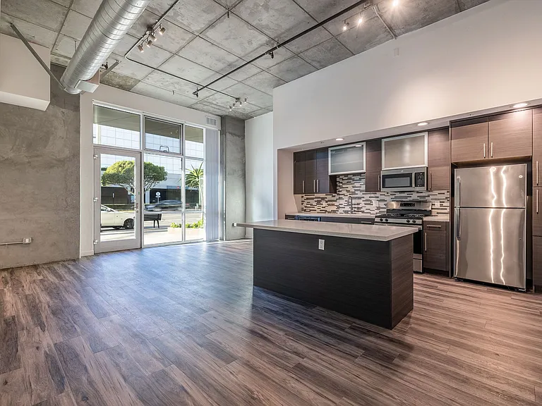 Open kitchen and living/work space in a Live and Work apartment at 1400 FIG Apartments in Los Angeles, California.
