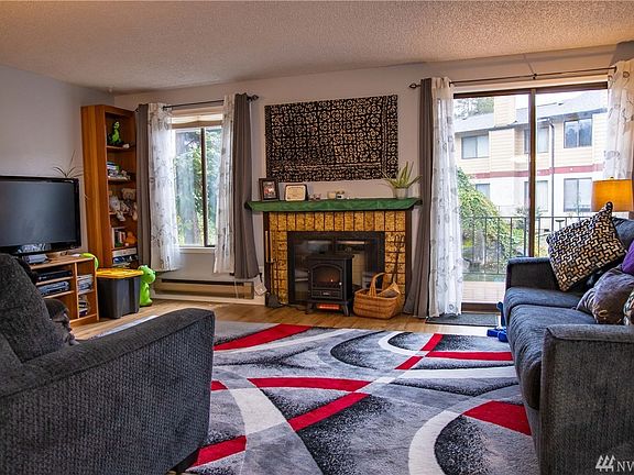 Spacious living room looks out into waterfall pond. 