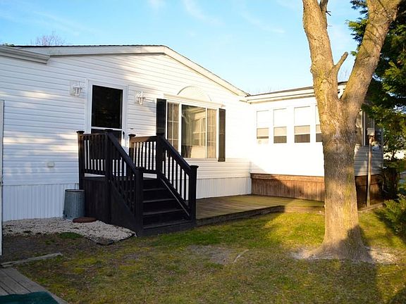 Side of home with nice wood patio/ Grilling Area and 3 Season Room!