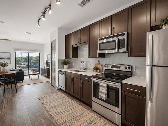 A kitchen with stainless steel appliances at Markethaus 3700 in Plano Texas