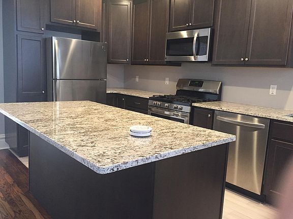 Kitchen showing center island, stainless appliances, and cabinets