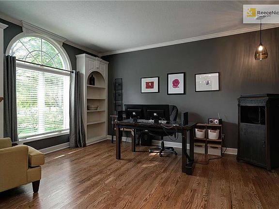 Main floor Office w/ hardwood flooring and built-in shelves.