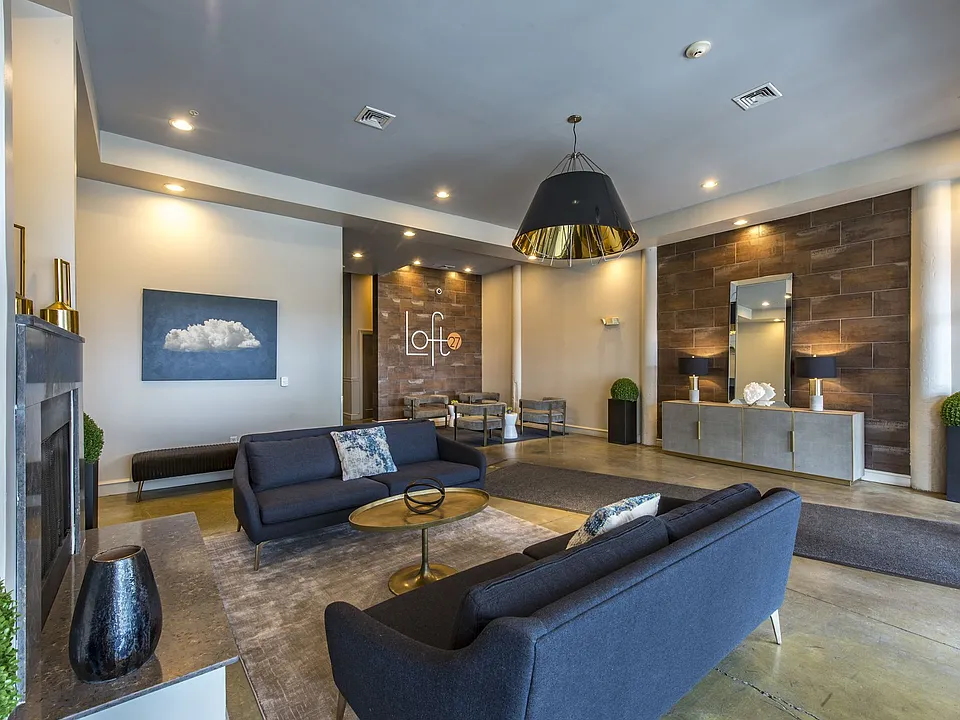 Resident clubhouse featuring lounge seating, entertainment space, and community kitchen