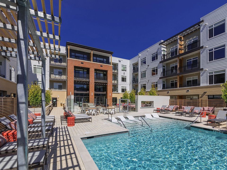 Resort-style swimming pool with sun shelf and water feature