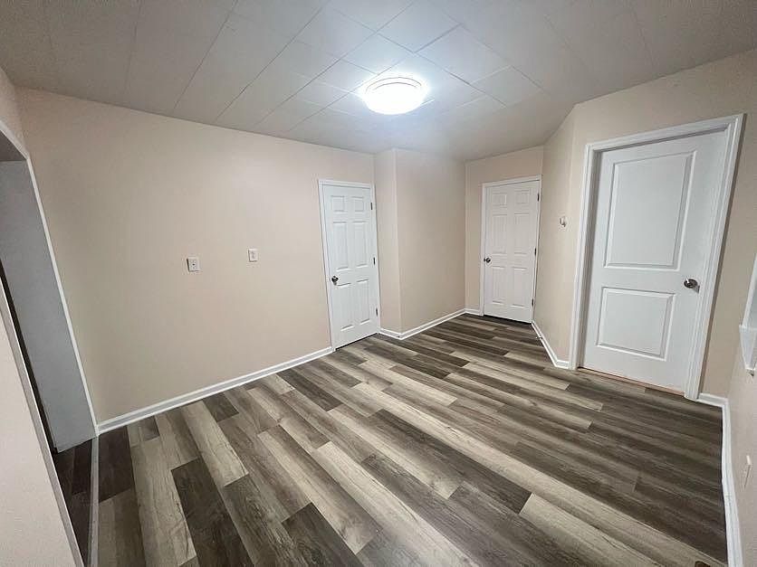 (Living room 1/3) Door on right is an exit, other 2 doors are bedrooms.