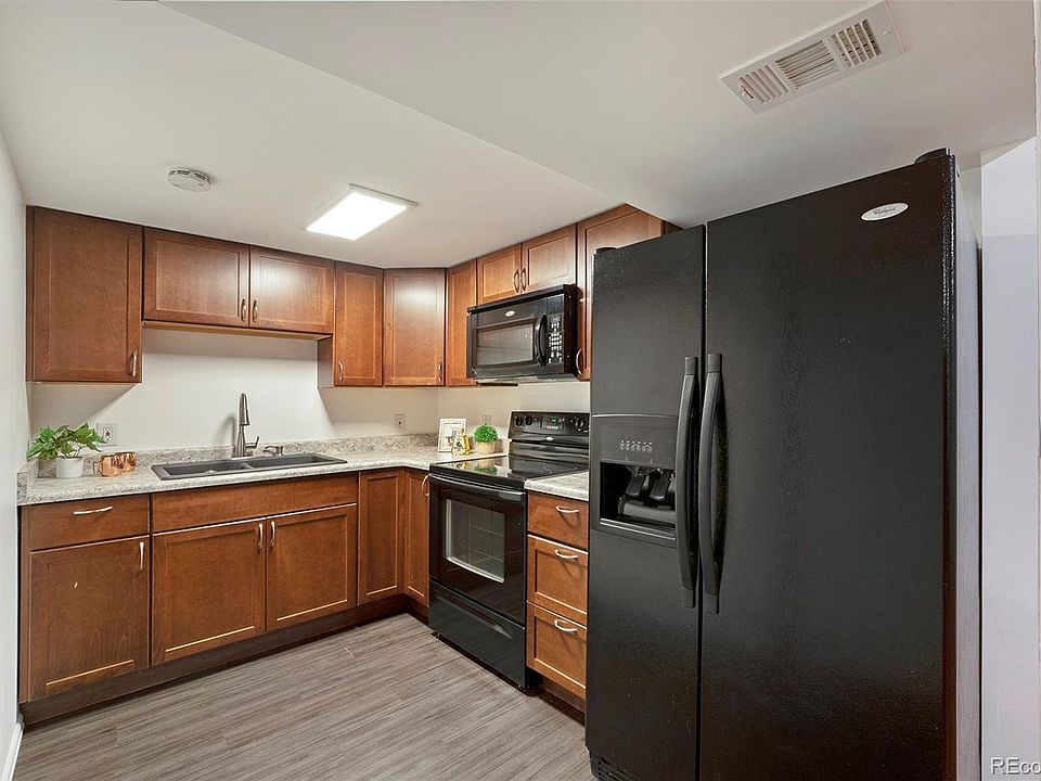 Downstairs kitchen with newer cabinets & appliances & deep granite sink.